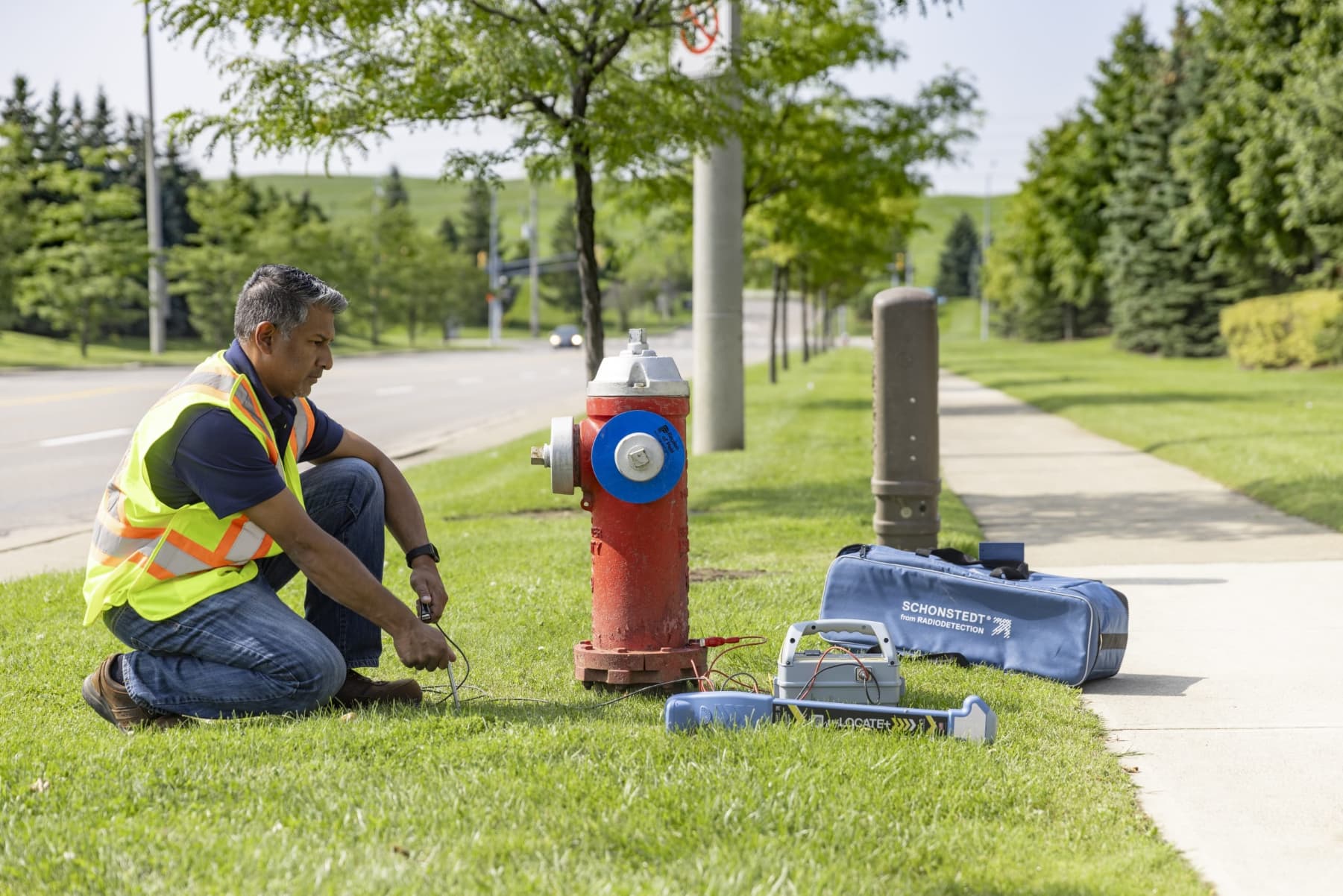 Worker with Schonstedt u-locate locating device